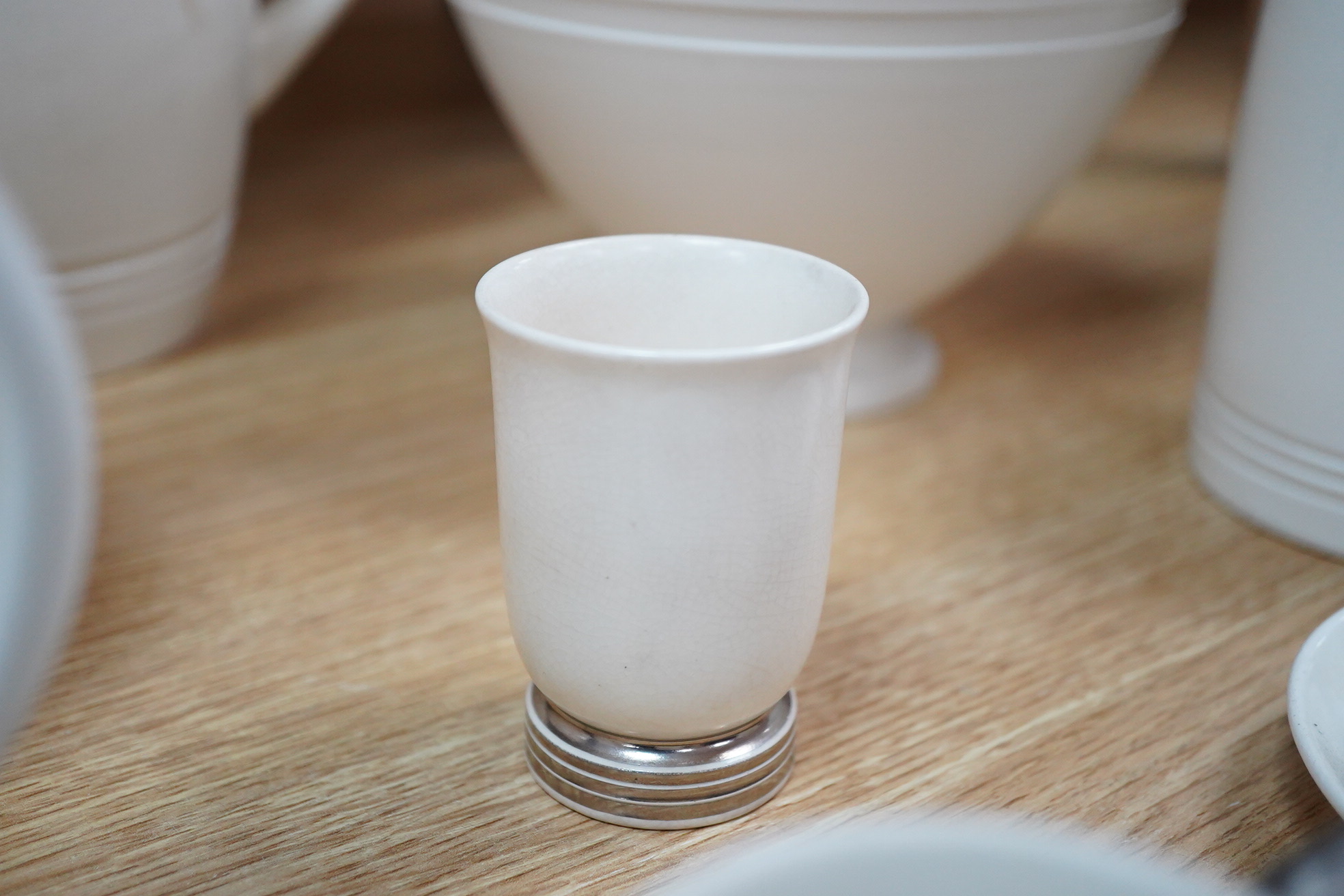 Keith Murray for Wedgwood, moonstone bowl, vase, jug, two mugs, coffee cups and small vase, largest 21cm high